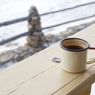 Extreme cold preparedness tips, featuring a coffee mug against a snowy backdrop