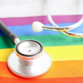 A stethoscope on top of a rainbow flag